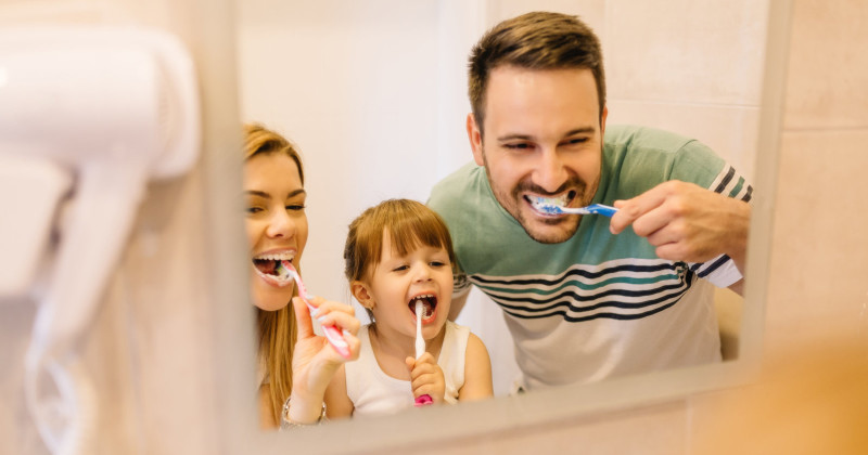 family brushing teeth