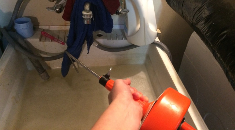 unclog toilet using auger
