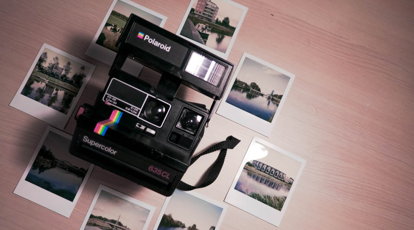 polaroid camera and photo prints