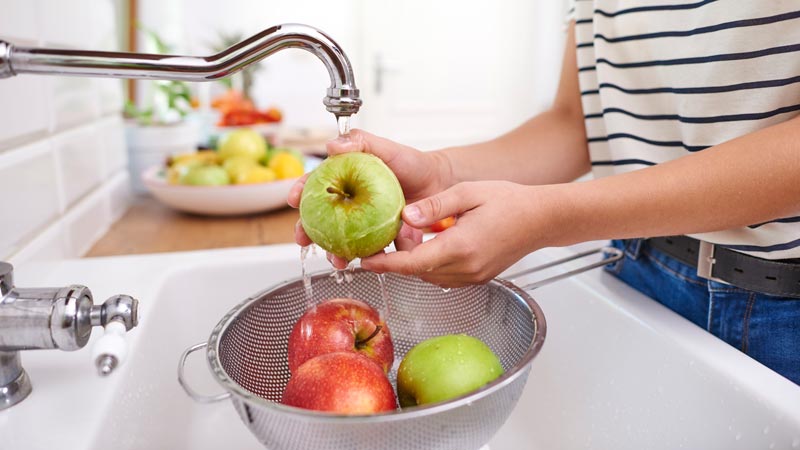 woman washing seasonal fresh apples